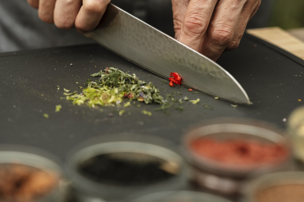 Chef hands working with fresh ingredients at the live table station