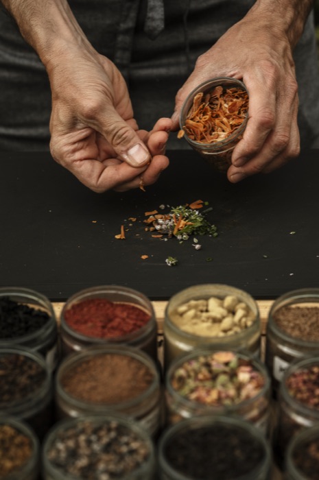 Chef interacting with guests to select spices and create their custom edible wedding favour