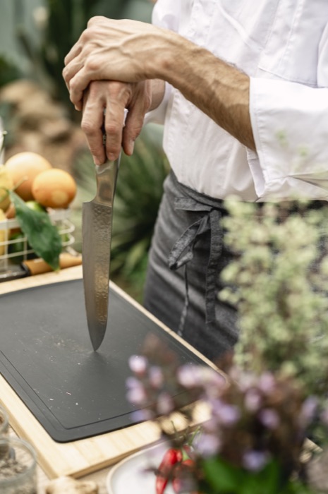 Chef welcoming guests during the welcome aperitif to create custom interactive wedding favours